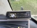 A Pioneer car stereo with a digital display and various buttons located in the interior of a 2005 Case 570 machine