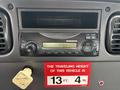A dashboard featuring a radio console and a sign indicating the traveling height of the vehicle is 13 feet 4 inches