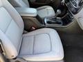 Interior view of a 2018 GMC Canyon showing the front seats and center console with gear shift and cup holders