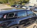 A black 2023 Fisker Ocean electric SUV with a sleek design and a panoramic sunroof showcases its modern features and stylish appearance