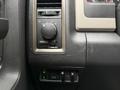Controls and switches on the dashboard of a 2012 Dodge Ram 5500 including a headlight switch and accessory power outlet