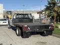 A 2020 Ford F-550 truck with a flatbed design and rear lights visible, showcasing its heavy-duty build and capacity for carrying cargo
