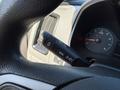 A close-up view of a steering wheel control stalk in a 2018 GMC Canyon showing buttons for menu settings and cruise control functions
