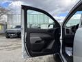 A 2018 Chevrolet Colorado with an open driver's side door showcasing the interior features and door panel design