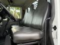 A grey vinyl bench seat in a 2011 International 4300 with two headrests and a simple interior design