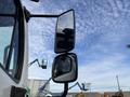 A close-up view of the side mirrors of a 2013 Freightliner 114SD truck showcasing the truck's sleek design and reflective surfaces