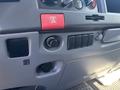Dashboard controls of a 2022 Isuzu NQR featuring buttons for emergency lights and various switches and knobs