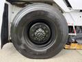 Close-up of a Goodyear tire mounted on a 2012 Global M4 vehicle with visible tread patterns and a metal wheel hub