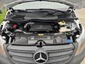 The engine compartment of a 2021 Mercedes-Benz Metris showing the engine block and various components including the battery and fluid reservoirs