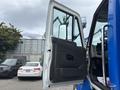 A 2013 International DuraStar 4300 truck with the driver's side door open displaying the interior and seat area