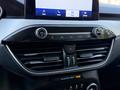Close-up view of the dashboard of a 2020 Ford Escape featuring audio controls climate vents and a touchscreen display