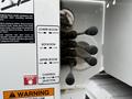 Close-up of control levers on a 2020 International MV607 featuring switches for lower boom fold and unfold rotation and upper boom control