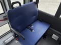 A blue fabric seat with seatbelt straps in a Chevrolet Express van interior