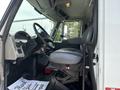 The interior of a 2012 International 7300 Workstar featuring a driver seat dashboard controls and floor mats with a thank you message