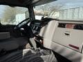 Interior view of a 2008 Kenworth T370 showing the dashboard steering wheel and seats with a textured design