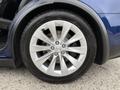 Close-up of a silver alloy wheel with ten spokes from a 2020 Tesla Model X featuring a black tire with tread pattern visible