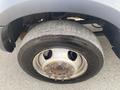 A close-up of a RAM 5500 truck wheel showing the steel rim and a worn tire with visible tread patterns