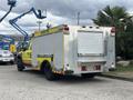 A yellow and silver 2010 Ford F-550 Super Duty fire truck with a metallic body and roll-up doors on the back