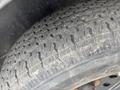 A close-up of a 2005 Katolight SED60FPJ4 tire showing its tread pattern and surface wear