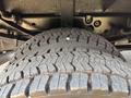 Close-up of a treaded tire of a 2009 Ford F-450 Super Duty showing the detailed pattern and grooves on the surface