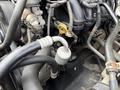 A close-up view of the engine components of a 2009 Toyota Hiace showcasing various pipes and connectors