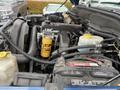 Engine compartment of a 2006 Dodge Ram 2500 showing various engine components and a yellow oil filter