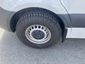 Close-up of a tire and wheel of a 2025 Mercedes-Benz Sprinter showcasing the tread pattern and alloy design