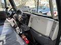 Interior view of a 2012 International DuraStar 4300 with a steering wheel dashboard and gray seat partially visible