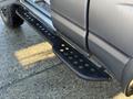 2004 Toyota Tacoma with a black step bar showing distinct holes for traction and a textured surface designed for easier access to the vehicle