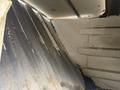 Interior of a 2012 Global M4 showing metal surfaces with signs of wear and rust along ridged walls