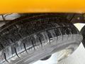 Close-up of a wet tire on a 2021 Ford Econoline showing detailed tread patterns and a shiny rim