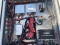 View of the interior electronics of a 2011 Chevrolet Express including multiple circuit boards wiring and connectors