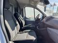 Interior of a 2017 Ford Transit van showing two front seats with fabric upholstery and a dashboard with controls