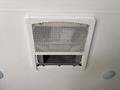 Ceiling air conditioning unit of a 2021 Jayco Jay Flight with a white vent cover and an open access panel below