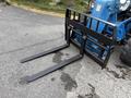 A 2020 Genie GTH-5519 forklift attachment with two long black forks positioned horizontally