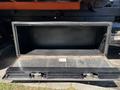 Open storage compartment of a 2016 Isuzu NPR-HD showing a steel interior with no contents visible