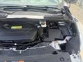 Under the hood of a 2014 Ford Escape showcasing the engine components including the air intake and battery area