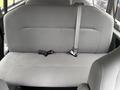 A gray bench seat from a 2013 Ford E-350 featuring seat belts on either side