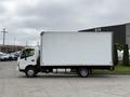 A white 2018 Hino 195 box truck is parked at an angle showing its side view with a large empty cargo area and a slight profile of the front cabin