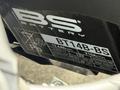 A close-up of a BS brand motorcycle battery label displaying model BT14B-BS with specifications and information about its maintenance and charging requirements