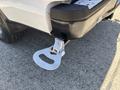 A close-up of a 2019 Ford F-150's rear bumper with a metal step attached for easier access to the truck bed