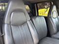 A pair of gray leather seats in the cabin of a 2005 GMC C7500 Topkick with a textured finish and visible stitching