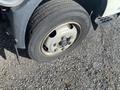 A close-up of the front tire of a 2019 Hino 195 showing the wheel rim and tire tread on a gravel surface