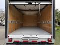 A 2022 Ford E-450 box truck with an empty cargo area featuring wooden walls and a flat gray floor