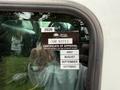 A 2016 Peterbilt 348 truck window displaying a Certificate of Approval sticker with information for British Columbia and expiration months listed