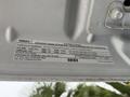 A 2015 Ford F-450 truck with a label detailing important engine and vehicle emission control information