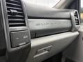 A close-up view of the dashboard of a 2019 Ford F-350 Super Duty featuring climate control vents and a compartment with a power outlet