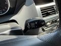 A steering wheel control stalk in a 2004 BMW 6-Series with buttons for windshield wipers and headlights