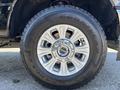 A close-up of a 2022 Ford F-350 SD wheel featuring a chrome alloy rim and Goodyear Wrangler tire with a rugged tread pattern