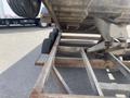 2009 Load 16 foot Dump Trailer with visible rust and metallic frame showing undercarriage and wheels